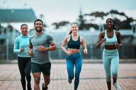 Sculpting Sleek Arms: The Essential Role of Cardio in Toning Without Bulking Up 3 image of people running to incorporate cardio Stanmore exercise into their life to help tone arms and body.