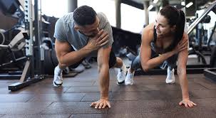Sculpting Sleek Arms: The Essential Role of Cardio in Toning Without Bulking Up 1 Image of man and woman doing Cardio Stanmore to tone their arms.